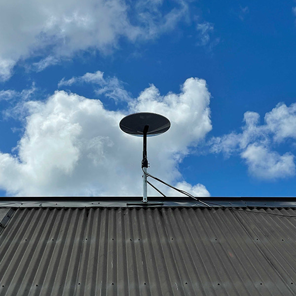 starlink satellite dish on roof with open view of sky
